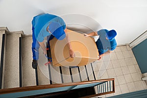 Two Movers With Box On Staircase