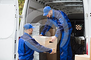 Two Movers Carrying Cardboard Box