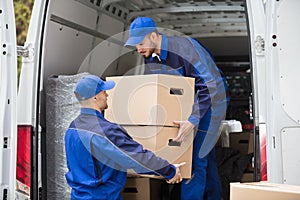 Two Movers Carrying Cardboard Box