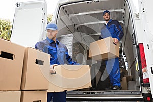 Two Movers Carrying Cardboard Box