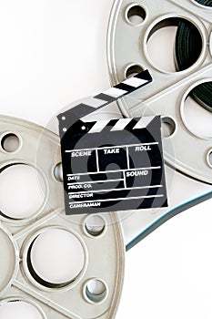 Two movie reels for 35 mm film projector with clapper board and
