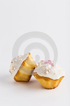 Two muffins with chocolate glazed and confit on a white background, isolated