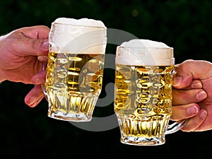 Two mugs of beer with us beer foam