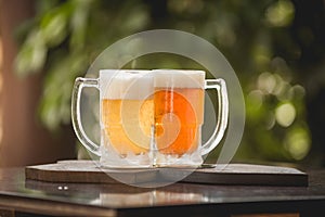 Two mugs of chopp on the table