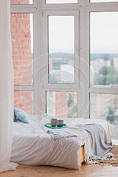 Two mugs on a tray white bed, breakfast concept