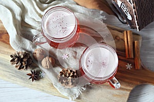 Two mugs of winter craft beer in New Year decorations