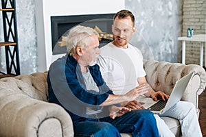 Two multi generation men sit on the sofa