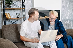 Two multi generation men sit on the sofa