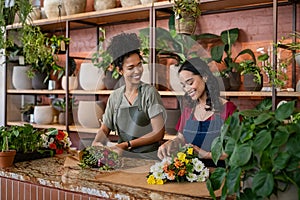 Two multiethnic women working in florist shop together