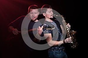Two musicians on a black background