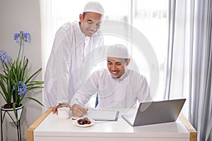 muslim business partner discussing and meeting using laptop