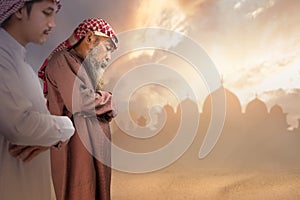Two Muslim men with agal in a praying position (salat photo