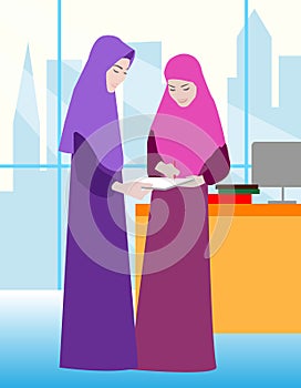 Two Muslim women work in the office. Happy young women or girls. Group of female friends, union of feminists, sisterhood