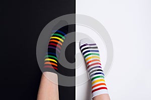 Two nagative legs with white and black striped colorful socks with negative background with copy space