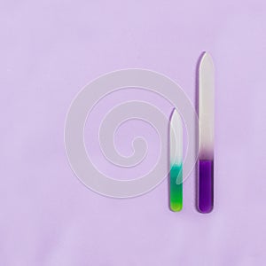 Two nail files on lilac background photo