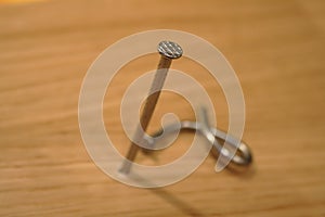Two nails on wooden background