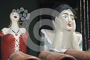 Two Namoradeiras, lover seraching wooden girls, on a window of T