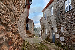 two narrow stone streets in an old european country village with stairs leading to the door photo