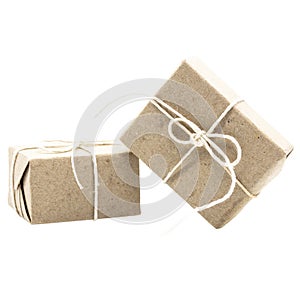 Two natural brown gift boxes or parcels with cord ribbon