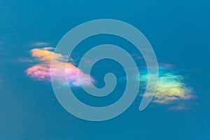 Two clouds with natural circumhorizontal arc in blue sky