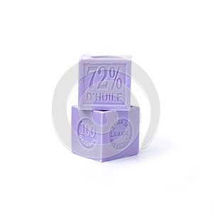 Two natural lavender soaps of a cubic form of lilac color with the inscription in French: Marseille lavender soap, 100