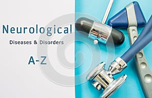 Two neurological hammer and stethoscope lay near book inscribed with Neurological Disorders & Diseases A-Z. Neurologist or interna