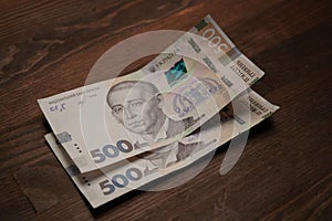 Two new five hundred hryvnia notes. New Ukrainian 500 hryvnias paper banknotes on table. Cash money concept. Deposit