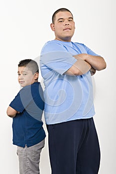 Two Obese Brothers Standing Back To Back