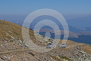 Two off-road cars on the mountain