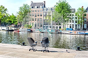 Two office chairs opposite the buildings