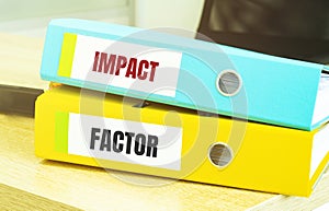 Two office folders with text impact factor