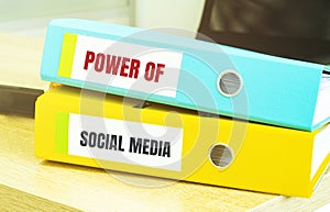 Two office folders with text power of social media