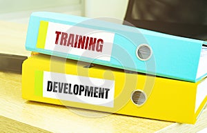Two office folders with text TRAINING DEVELOPMENT