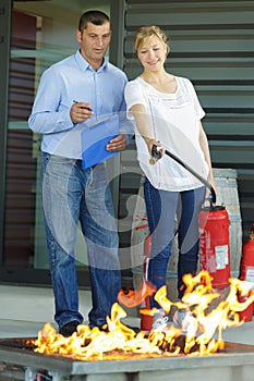 two officer using fire extinguisher in fire fighting training