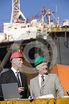 Two oil platform inspectors with a laptop