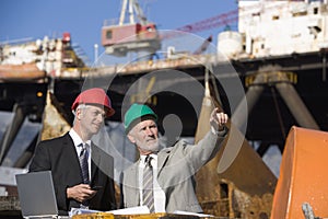 Two oil platform inspectors with a laptop