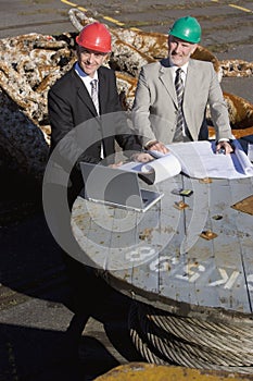 Two oil platform inspectors with a laptop