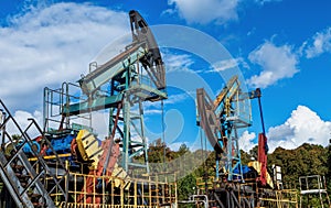 Two oil pumps during operation. Operation and maintenance of oil wells