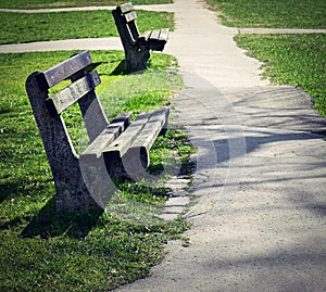 Two old abandoned benches in park