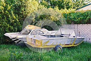 Two old abandoned boats in the yard