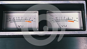 Two old analog dial vu signal indicators with arrow