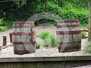 Two old barrels on a wooden barn floor