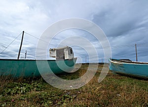 Two old blue boats on shore