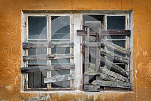 Two old boarded-up window on the wall