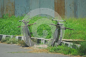 Two old bycycle on the road at the rice field