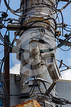 two old cctv security surveillance cameras on street light pole on blue sky background