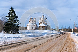 Two old churches by the road in the winter landscape. Paltoga