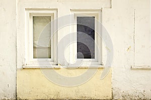 Two Old Closed Windows in the Old White Concrete Wall
