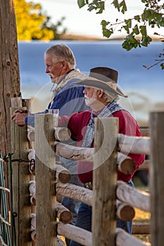 Two Old Cowboys Standing by Rail Fence photo