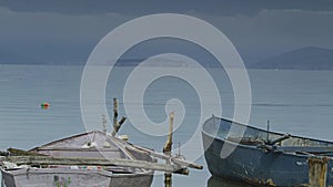 Two old fishing boats sitting on the bay